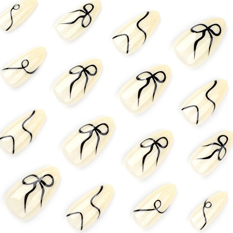 StarNagel Almond Nägel in Weiß und Schwarz mit Streifen und Schleifen