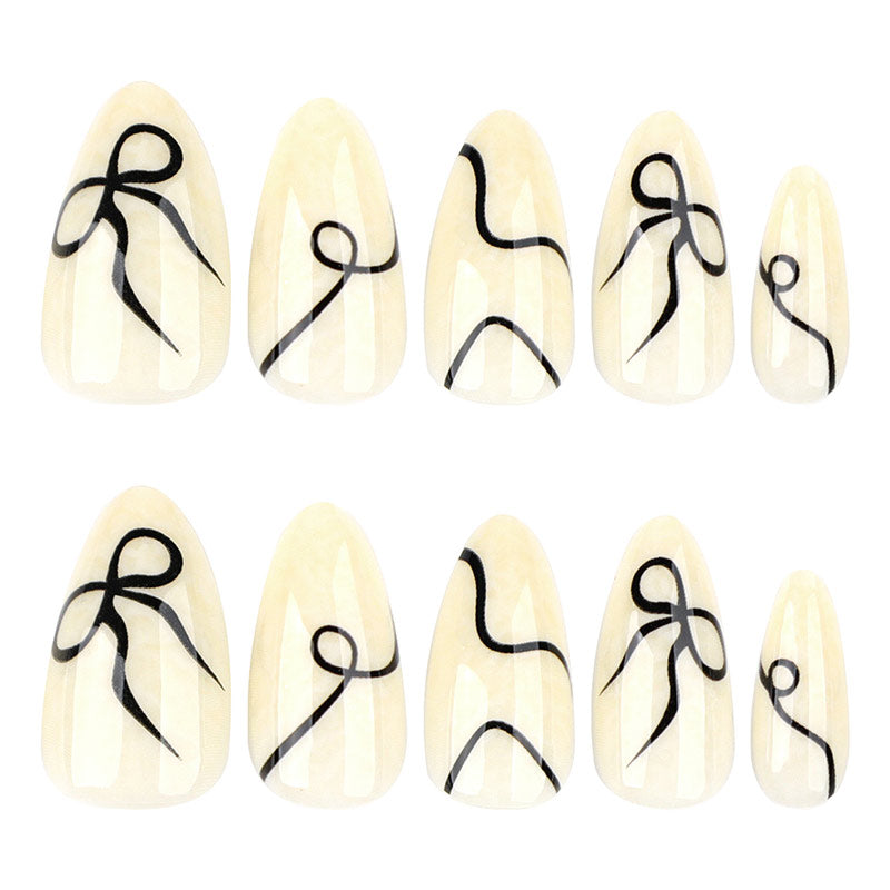 StarNagel Almond Nägel in Weiß und Schwarz mit Streifen und Schleifen