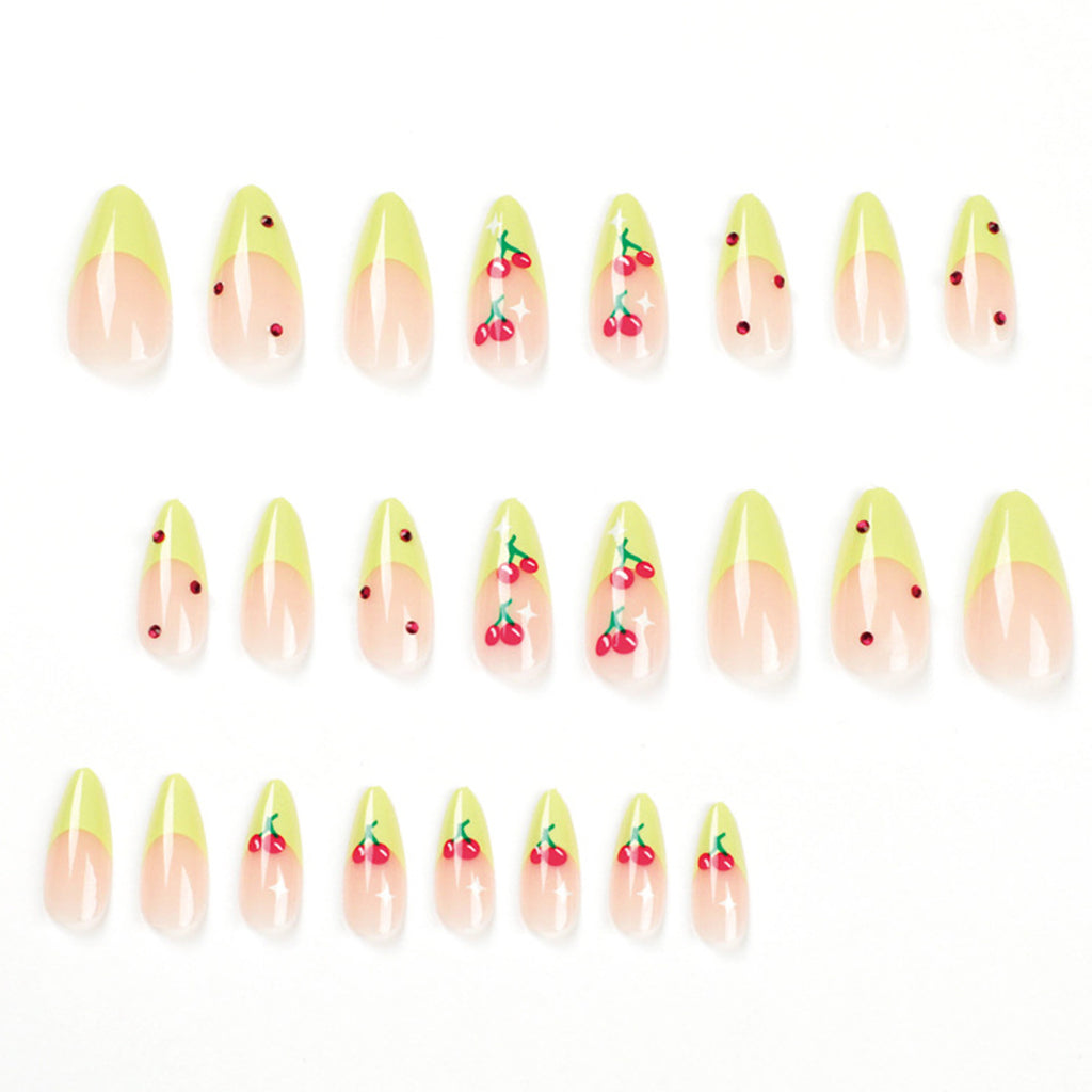 StarNagel Stiletto Nägel French Maniküre mit grünen Rändern, roten Diamanten und kleinen Kirschen